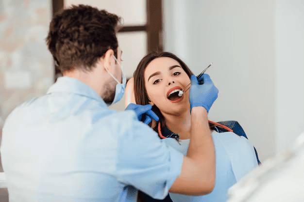 dentist-making-professional-teeth-cleaning-withb-cotton-female-young-patient-dental-office_496169-907